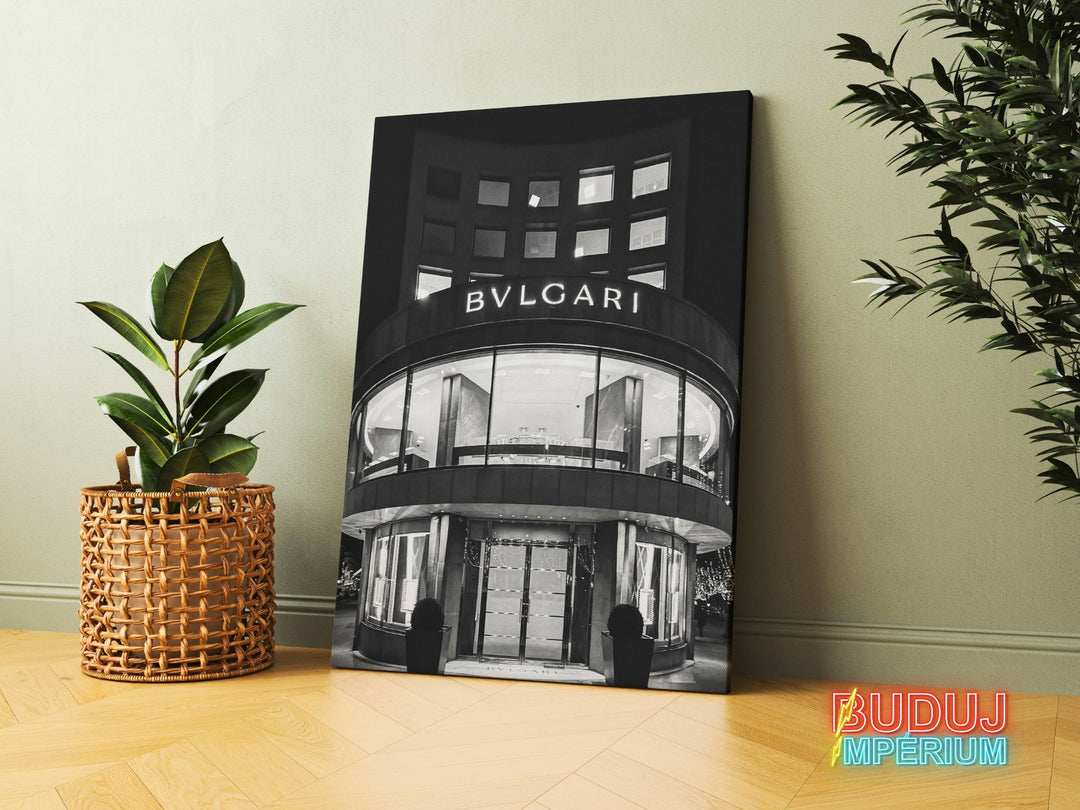 Luxury canvas print with a black and white photograph of a Bvlgari boutique entrance, leaning against a wall beside a green plant