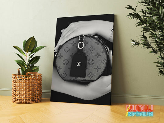 Luxury canvas print with a black and white detail of hands holding a handbag in a modern interior