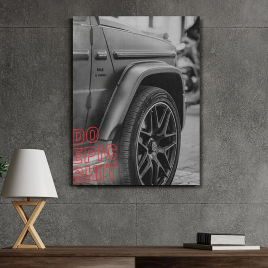 Motivational canvas wall art with a luxury SUV wheel detail and red Do Epic Shit text in a modern office.