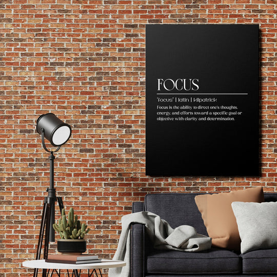 FOCUS motivational wall art with a minimalist definition on a brick wall in a modern living room