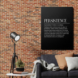 Motivational canvas print with a white quote on a black background above a gray sofa by a brick wall
