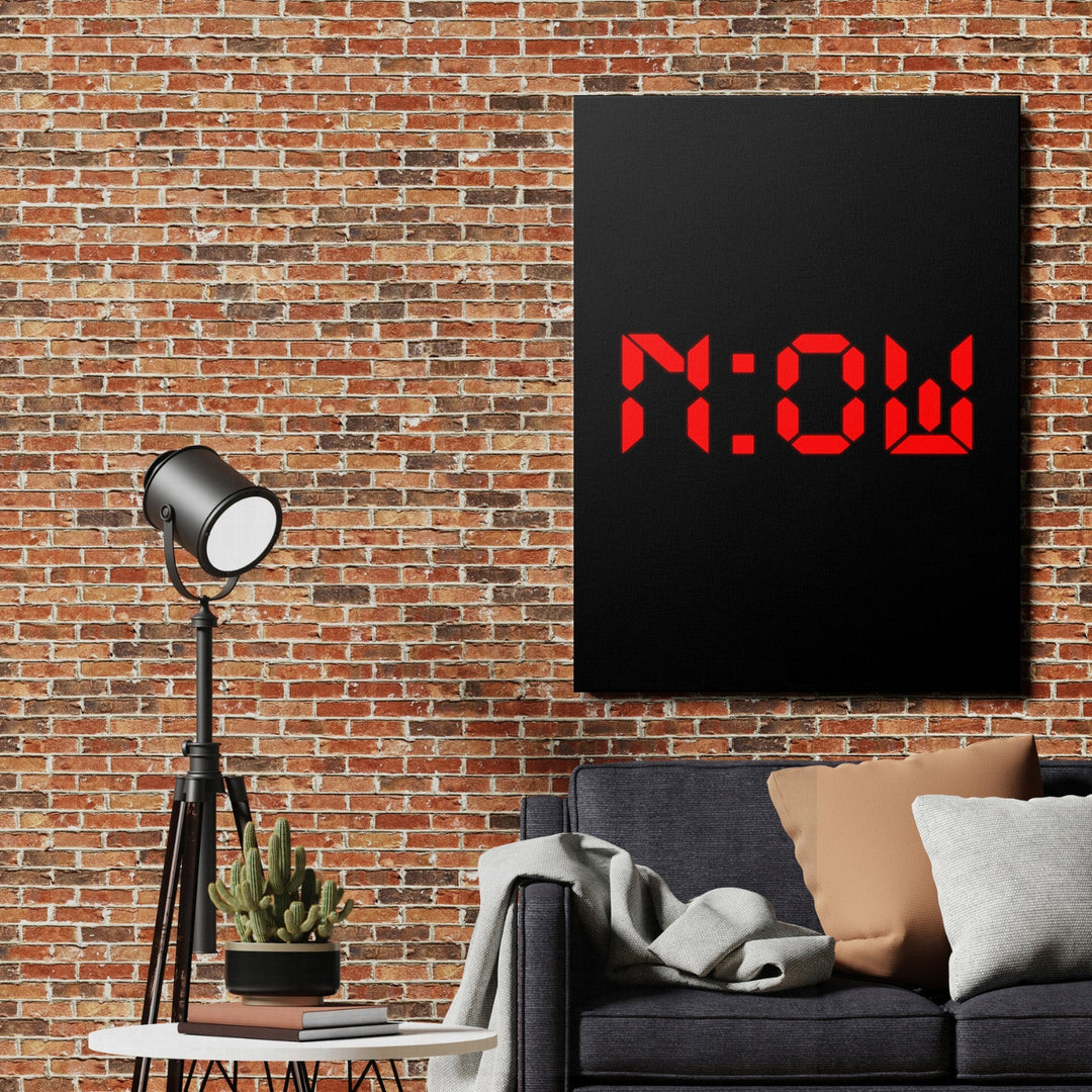 Motivational wall art with red neon NOW lettering in an industrial living room