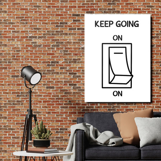 Keep Going On motivational wall art in a living room with a brick wall and minimalist calendar design