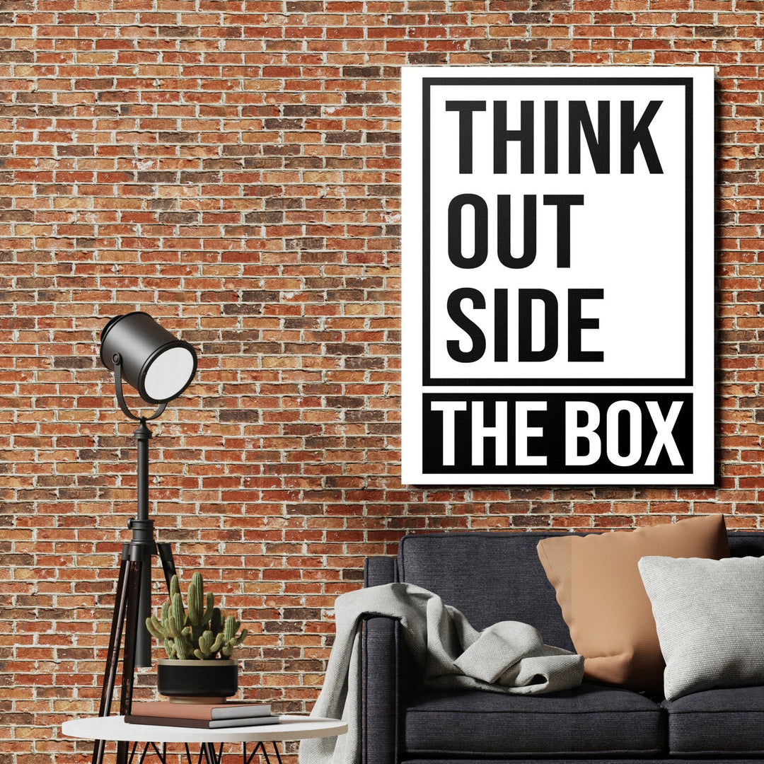THINK OUTSIDE THE BOX motivational canvas print on a brick wall in an industrial living room