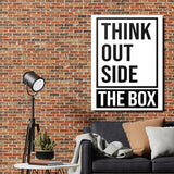 THINK OUTSIDE THE BOX motivational canvas print on a brick wall in an industrial living room