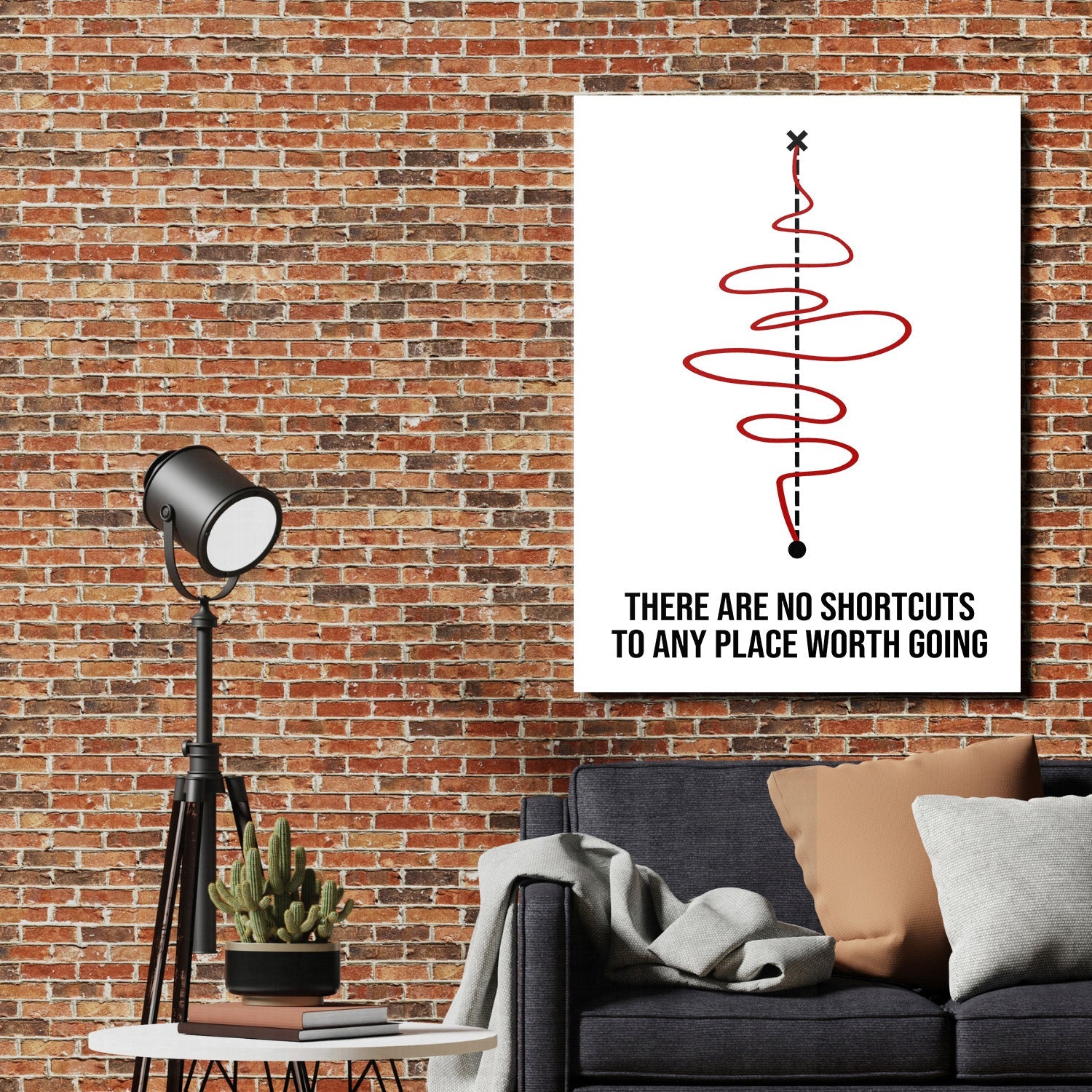 Motivational canvas print with a red spiral and quote on a brick wall in a living room