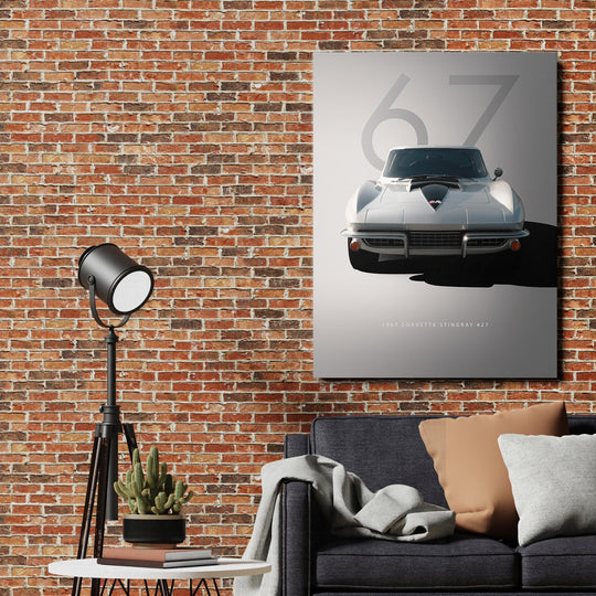 Motivational canvas wall art with a Corvette Stingray 427 front view in a minimalist living room with a brick wall