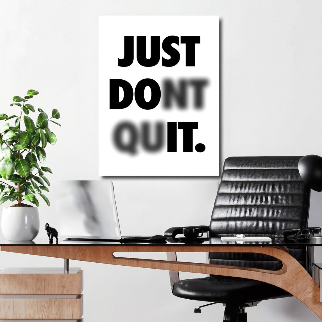 Just Don’t Quit black and white motivational canvas print above a work desk in an office