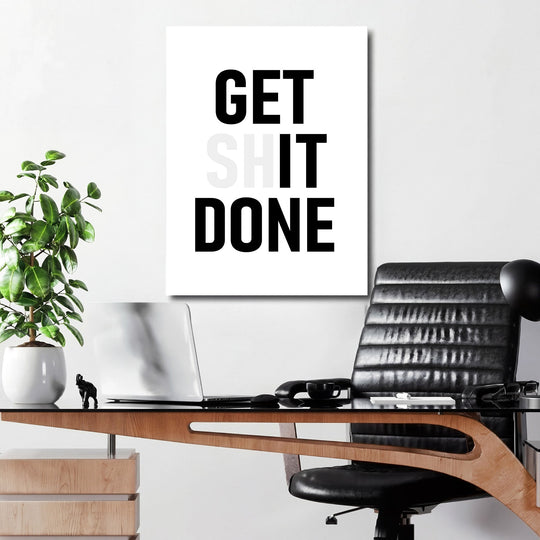 GET SHIT DONE motivational wall art above a work desk in a modern office