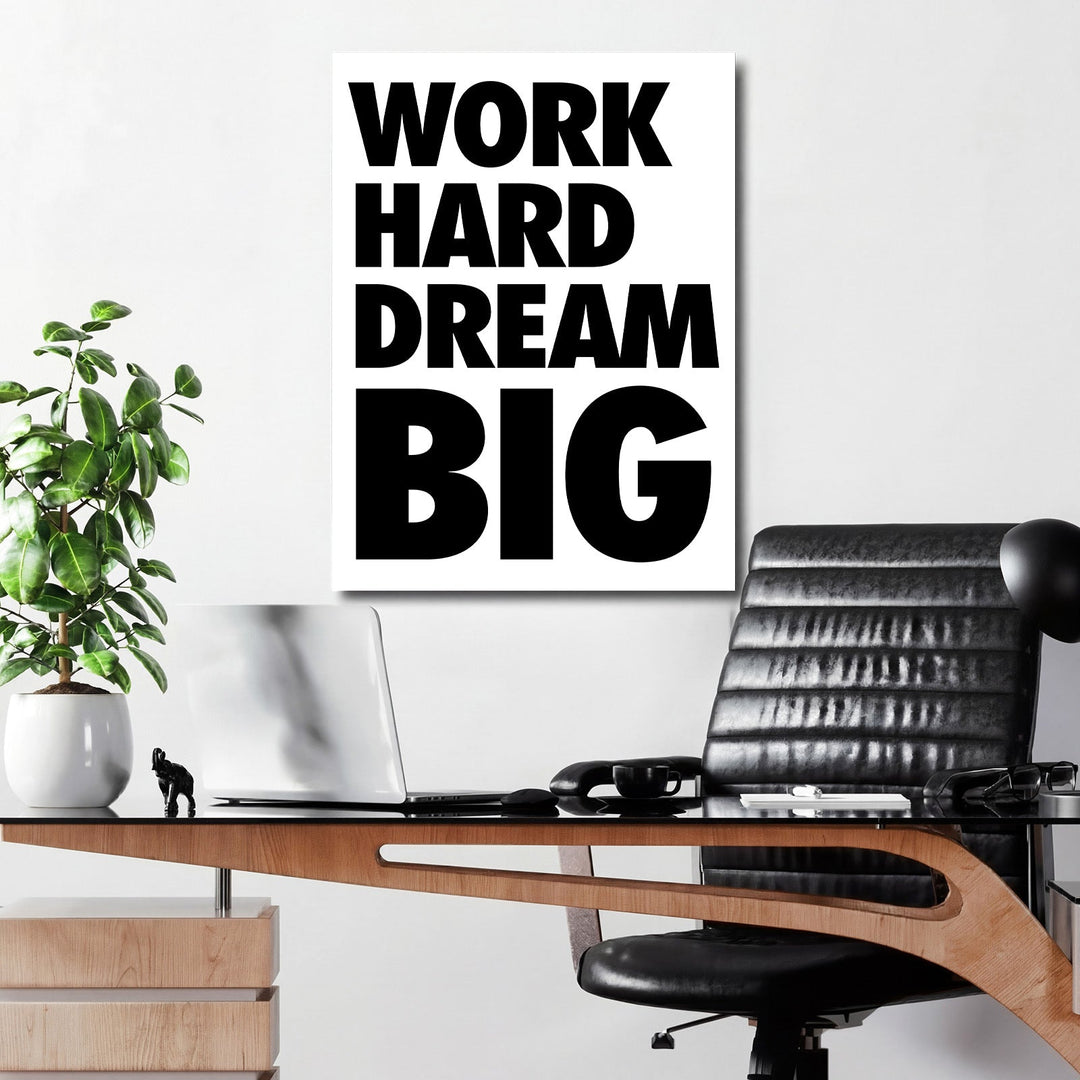 WORK HARD DREAM BIG motivational canvas wall art on a white office wall above a desk with a plant and black chair