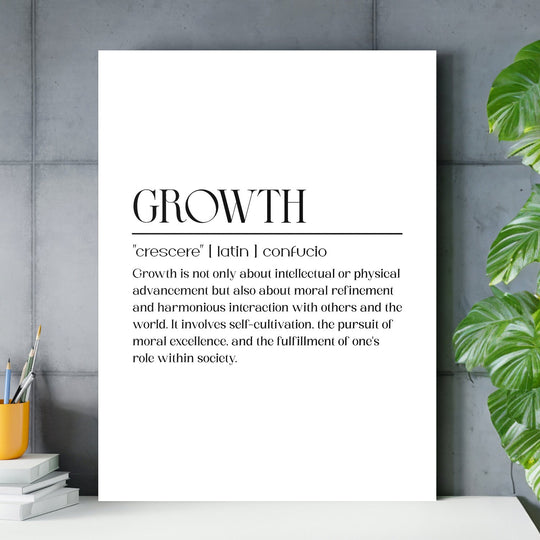 Growth motivational canvas wall art with black typography in a modern office with a concrete wall, plant and pencil cup