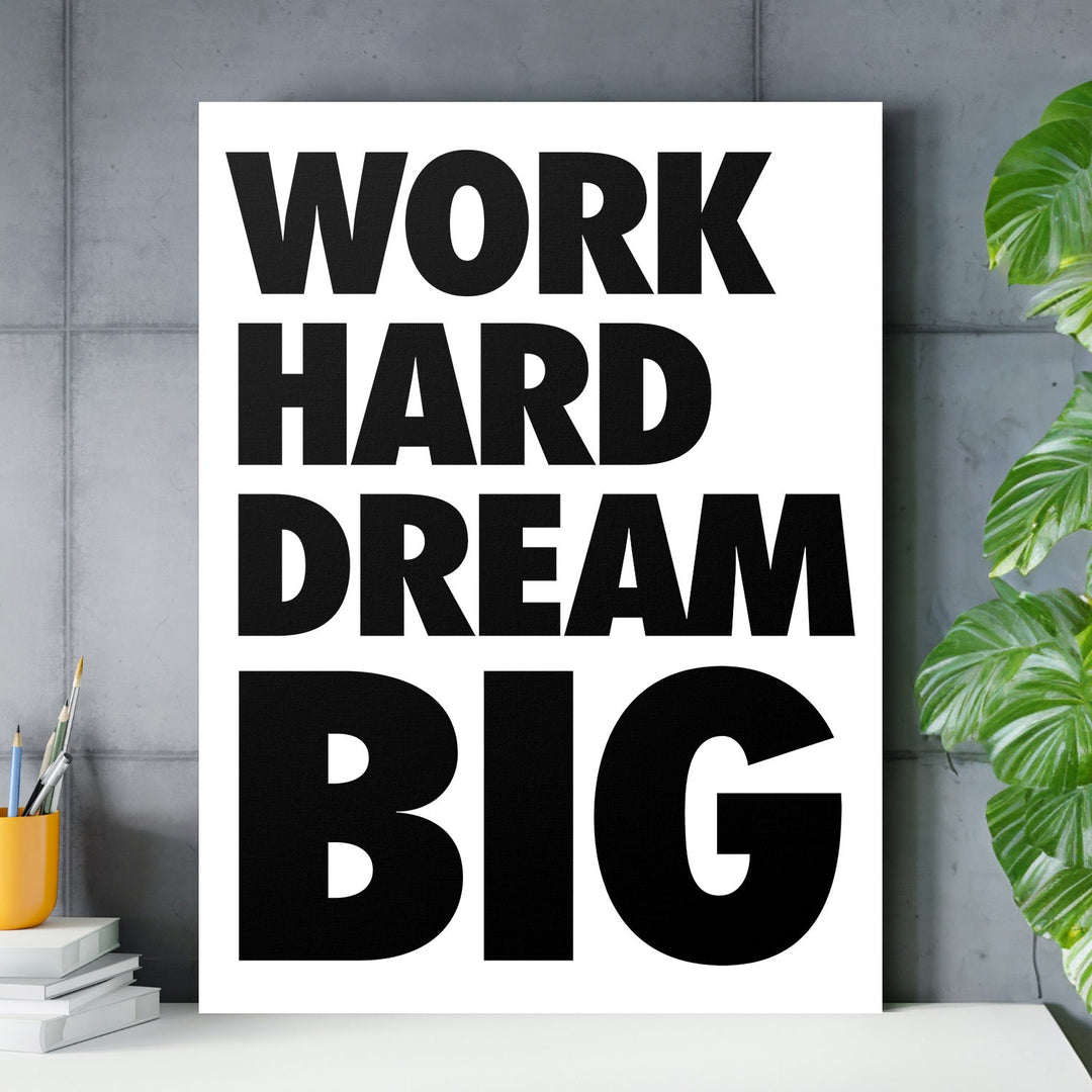 WORK HARD DREAM BIG motivational canvas wall art with black typography hanging in a modern office