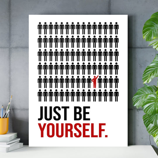 Motivational canvas wall art with black figures and one red figure above the “JUST BE YOURSELF” text
