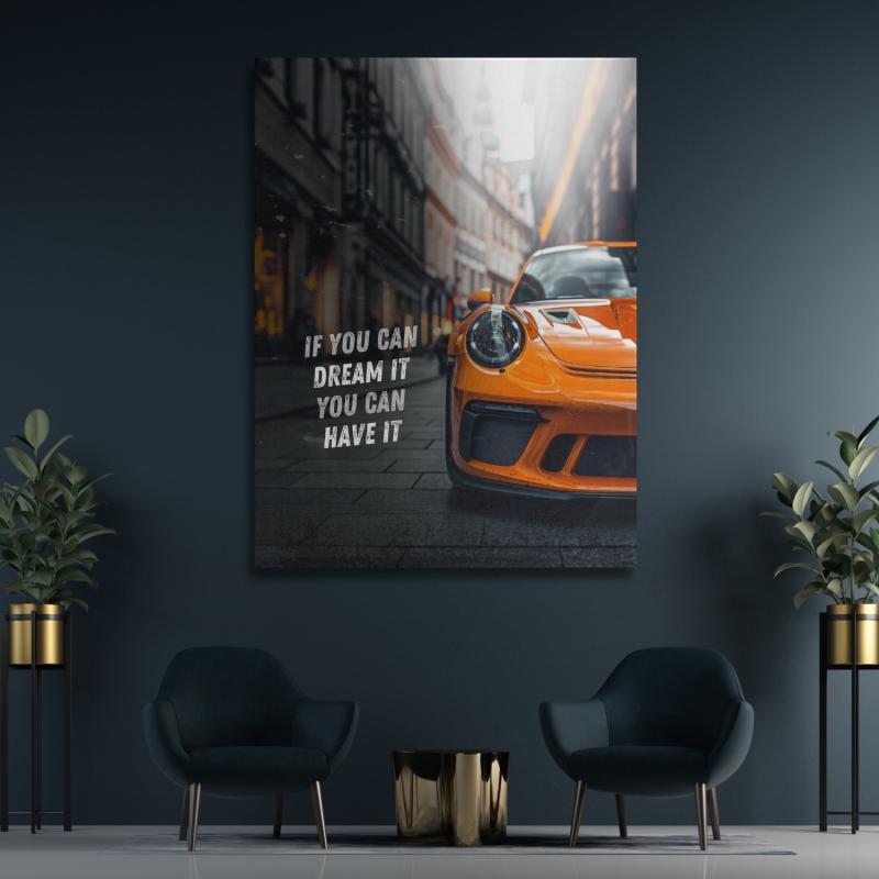 Motivational wall art with an orange sports car and quote in a modern living room, lifestyle decor.