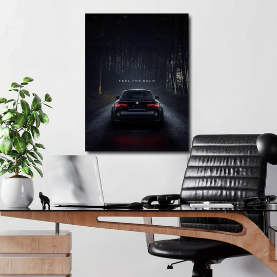 Motivational wall art with a night BMW in the forest and the text “Feel the Calm” above a desk