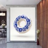 Motivational wall art with a blue-and-white porcelain donut and gold accents in a living room