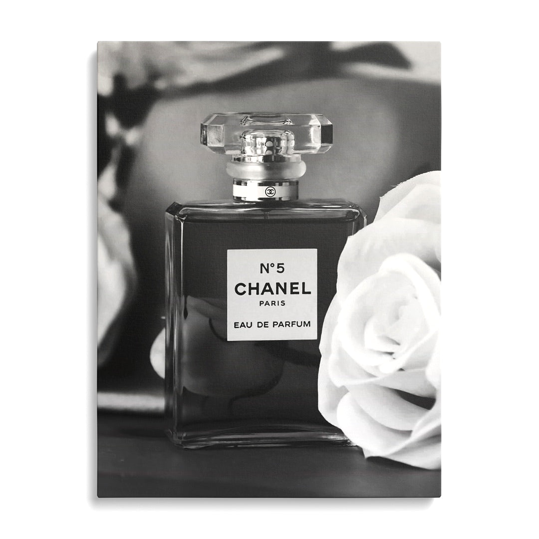 Chanel No. 5 modern canvas wall art displayed on a wall.