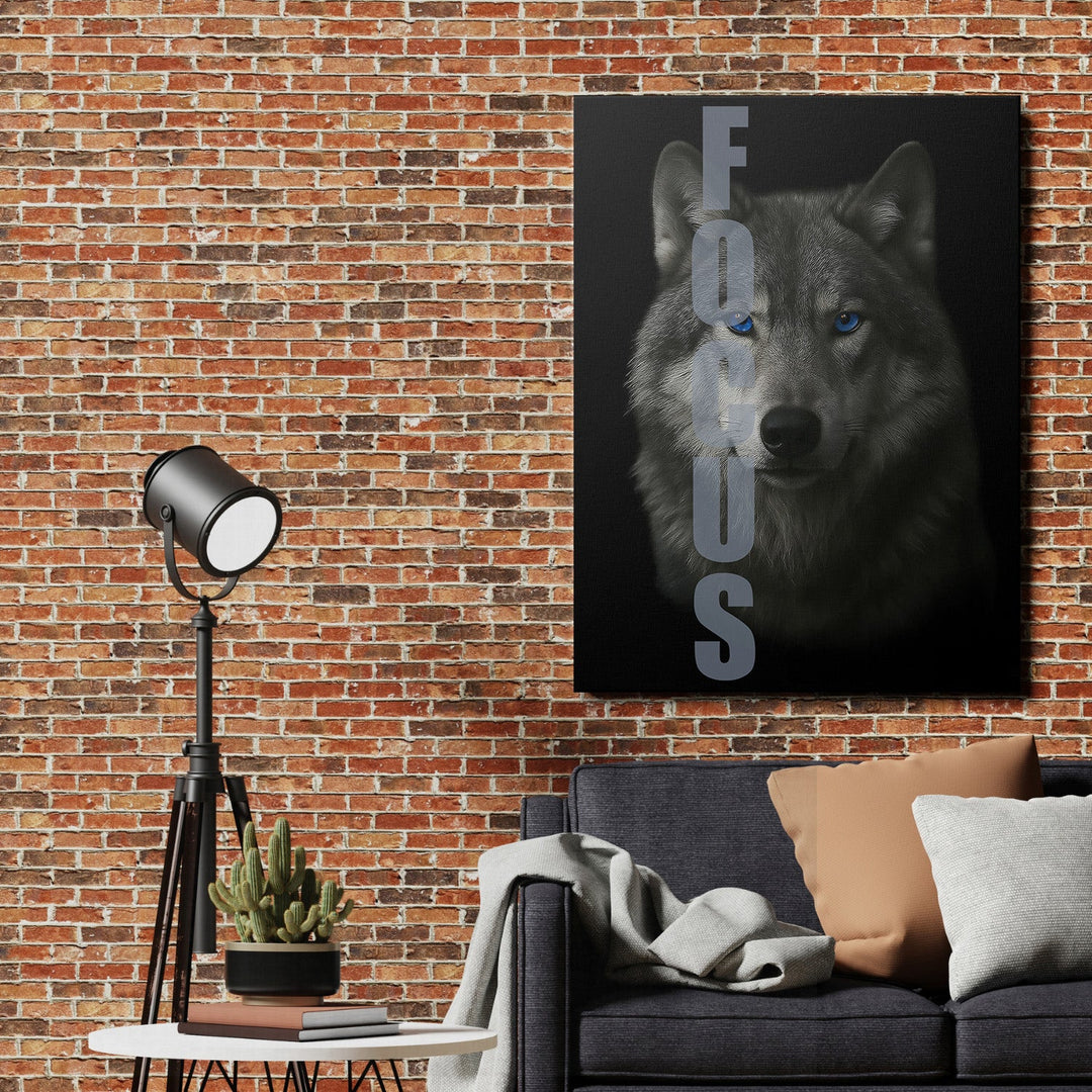 Motivational canvas wall art with a wolf and FOCUS text hanging on a brick wall in a modern living room.