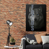 Motivational canvas wall art with a wolf and FOCUS text hanging on a brick wall in a modern living room.