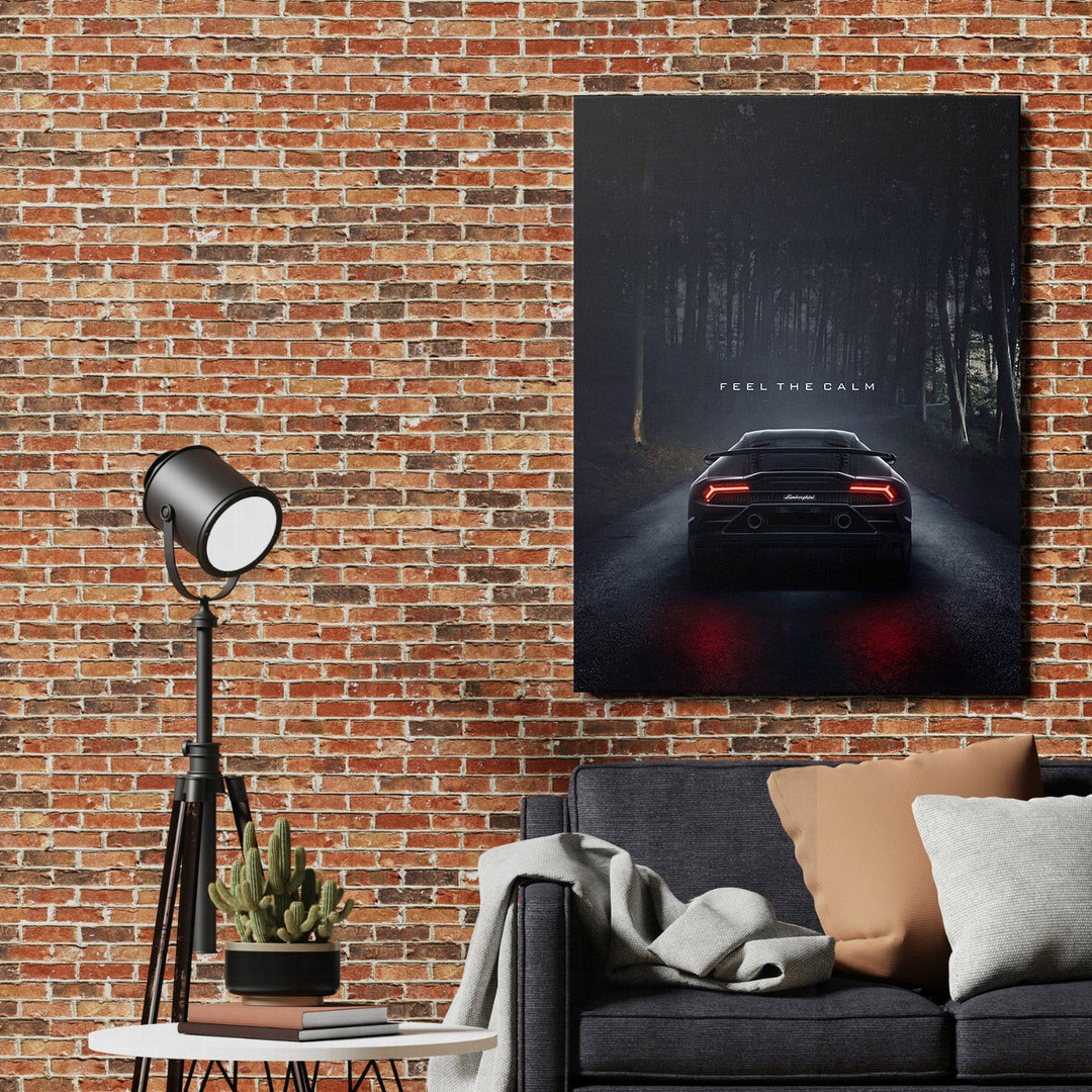 Motivational canvas print with a black supercar in a misty forest above a sofa in a modern living room