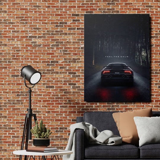 Motivational canvas print with a black supercar in a misty forest above a sofa in a modern living room