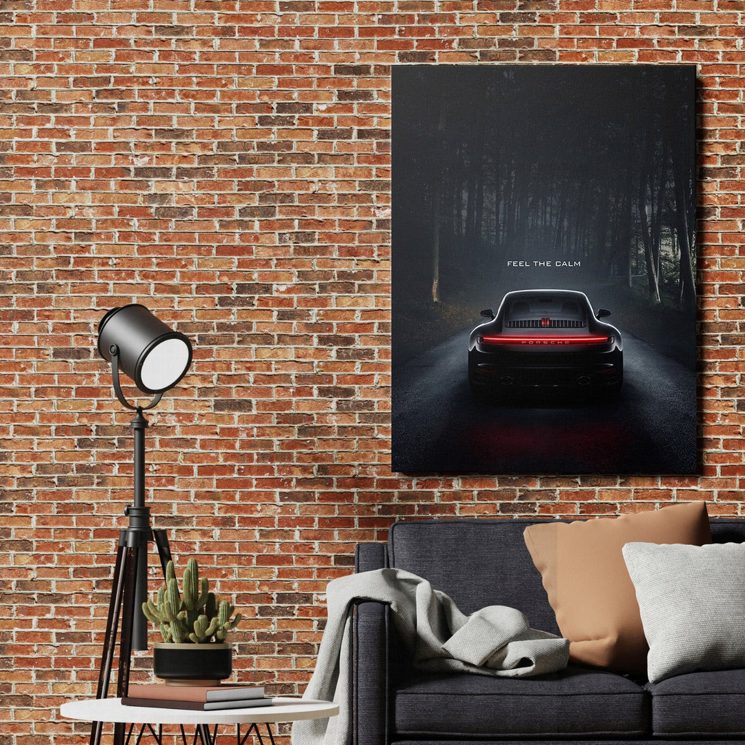 Luxury canvas wall art with black Porsche on dark forest road and text Feel the Calm in a living room