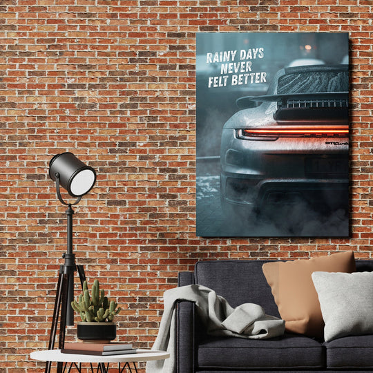 Motivational canvas wall art with rainy rear view of a Porsche and text Rainy Days Never Felt Better in an industrial living room