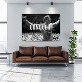 Motivational wall art with Arnold Schwarzenegger, a bodybuilder with outstretched arms and the word CONQUER.