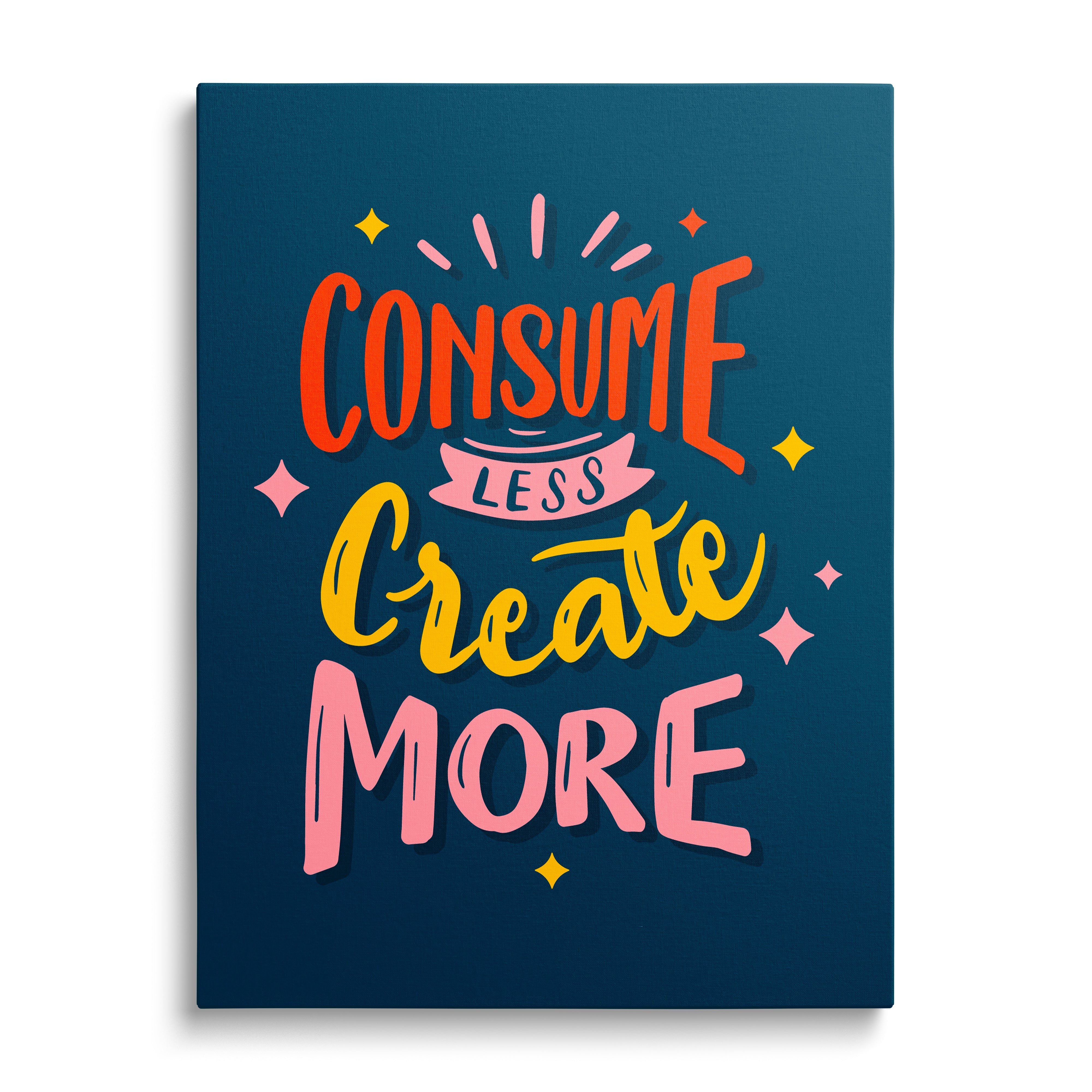 Motivational canvas print with the colorful quote “Consume less, create more” in a minimalist design