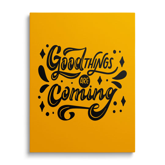 Motivational canvas print with the black phrase “Good things are coming” on a yellow background, front view