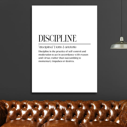 Discipline motivational canvas wall art with a quote in a modern living room above a brown leather sofa