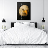 Motivational canvas wall art with an eagle and VISION text hanging in a minimalist bedroom.