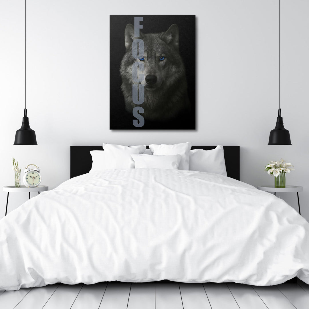 Motivational canvas wall art with a realistic wolf and FOCUS text in a modern minimalist bedroom.
