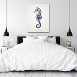 Motivational canvas print with a blue seahorse in a minimalist white bedroom