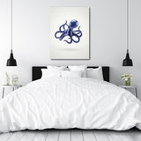 Modern canvas print with a stylized blue octopus above a double bed in a bedroom