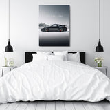 Motivational canvas wall art with black sports car and text I WILL NOT LOSE hanging in a white bedroom above the bed