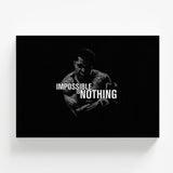 Motivational wall art with a black-and-white silhouette of Muhammad Ali and the bold typography quote “Impossible Is Nothing.”