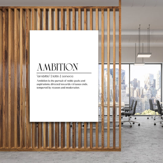 Motivational canvas wall art with a black and white “Ambition” inscription in a modern office behind a wooden partition