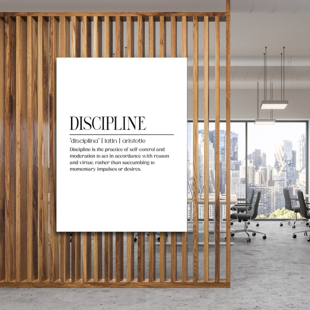 DISCIPLINE motivational canvas wall art with an Aristotle definition hanging in a modern office by a wooden partition