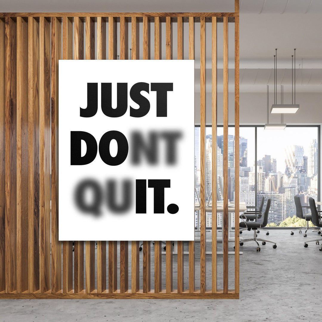 Just Don't Quit motivational canvas wall art with minimalist typography in a modern office behind a wooden partition