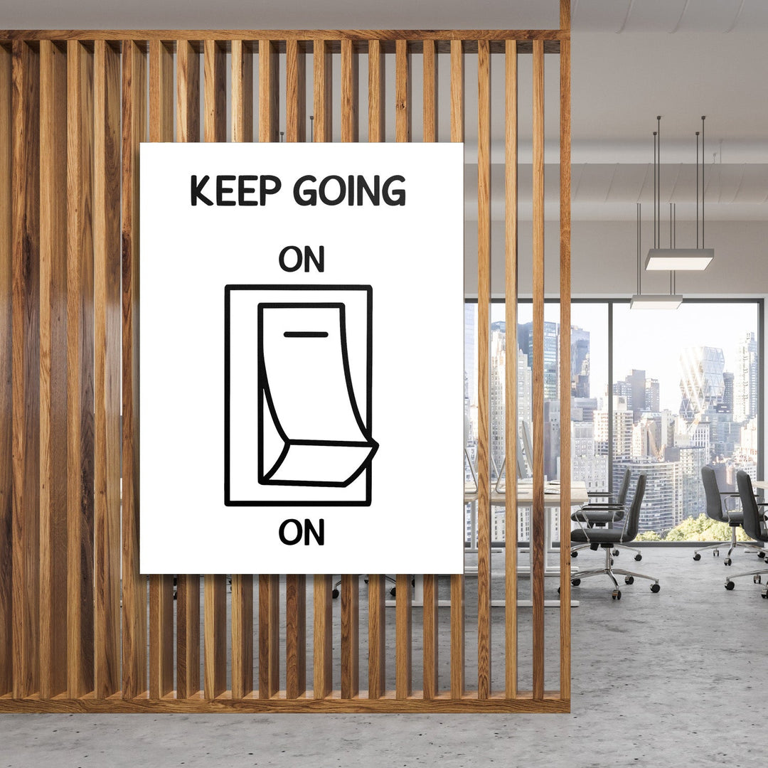 KEEP GOING motivational wall art with a black and white minimalist switch design in a modern office