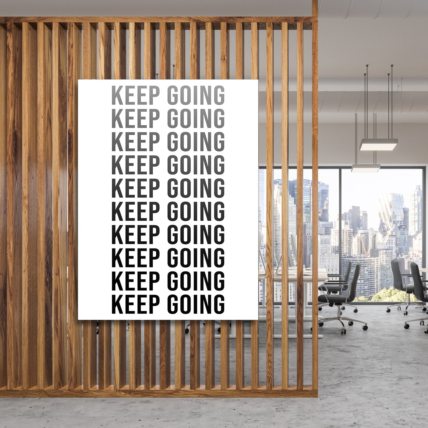 Black and white Keep Going motivational wall art with repeated text in a modern office