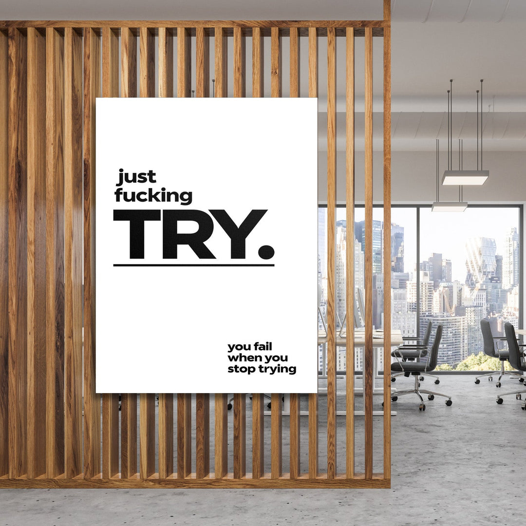 Motivational canvas print with a bold quote in a modern office behind wooden slats with a city view