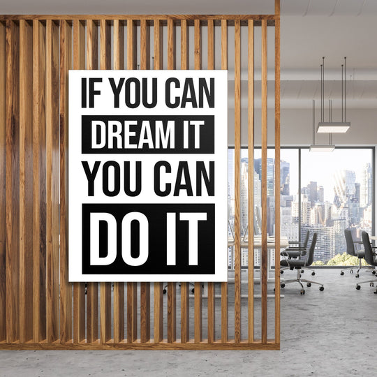 Motivational canvas wall art with a black and white quote in a minimalist modern office