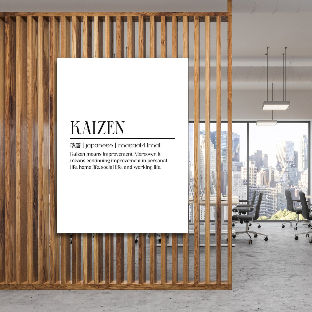 Kaizen motivational canvas wall art hanging on a wooden partition in an office with a city skyline view