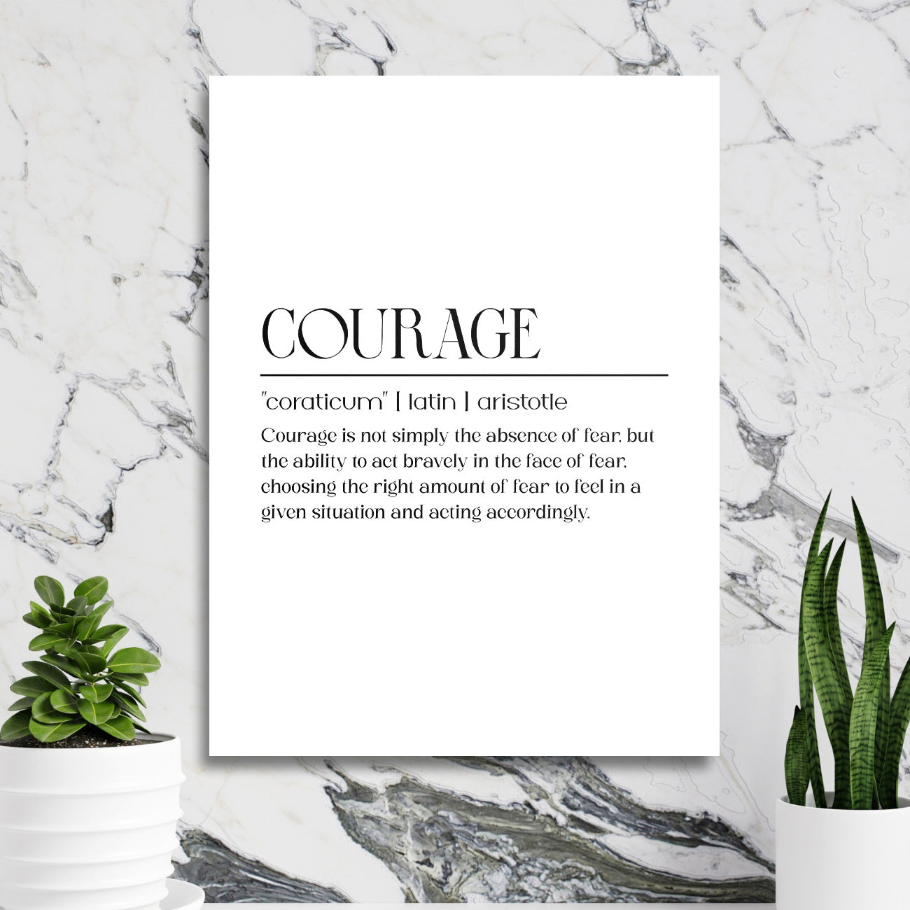 Motivational wall art with a “Courage” quote in a minimalist interior with a marble wall and green houseplants
