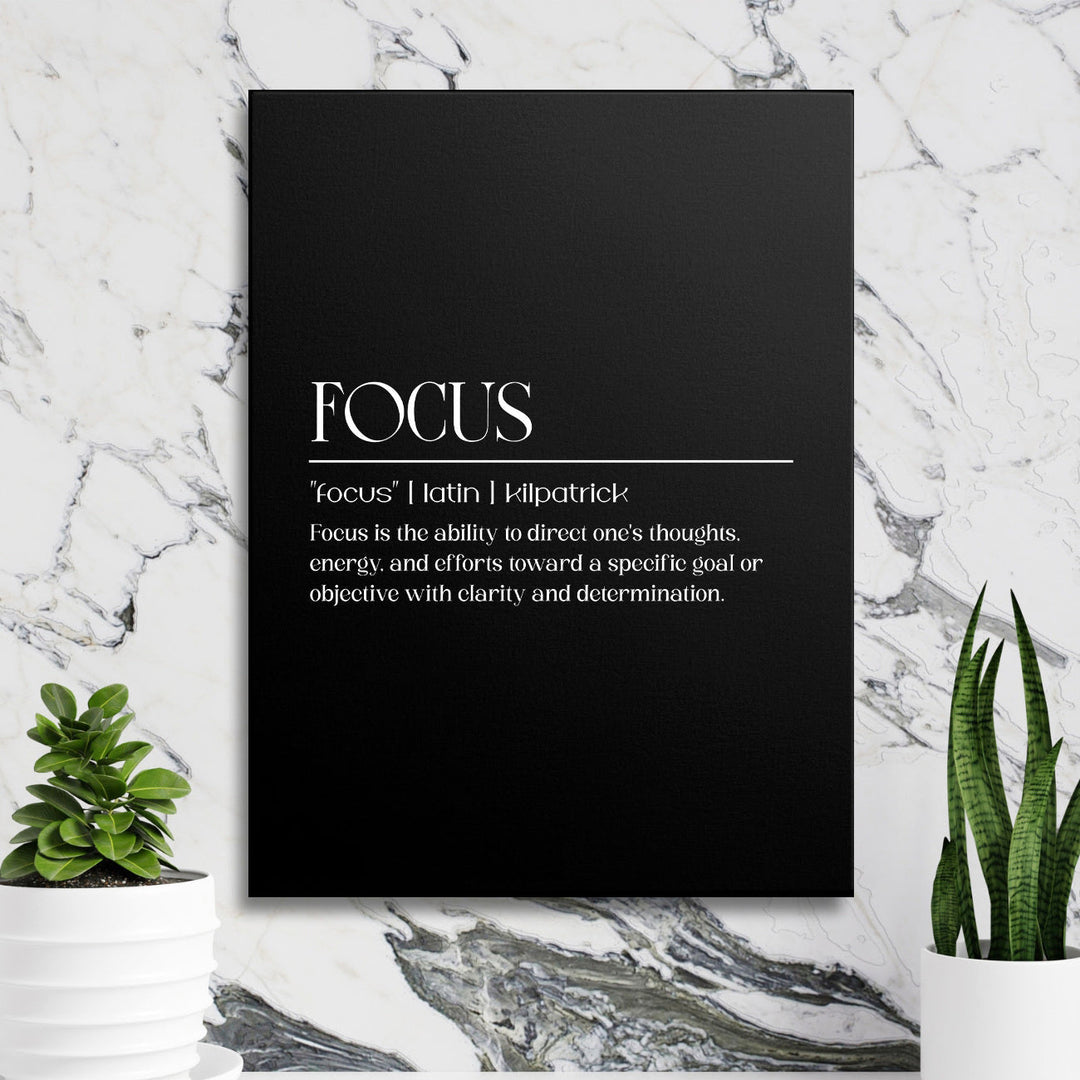 Focus motivational wall art with a black minimalist canvas and white typography in front of a marble wall