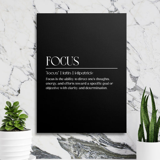 Focus motivational wall art with a black minimalist canvas and white typography in front of a marble wall