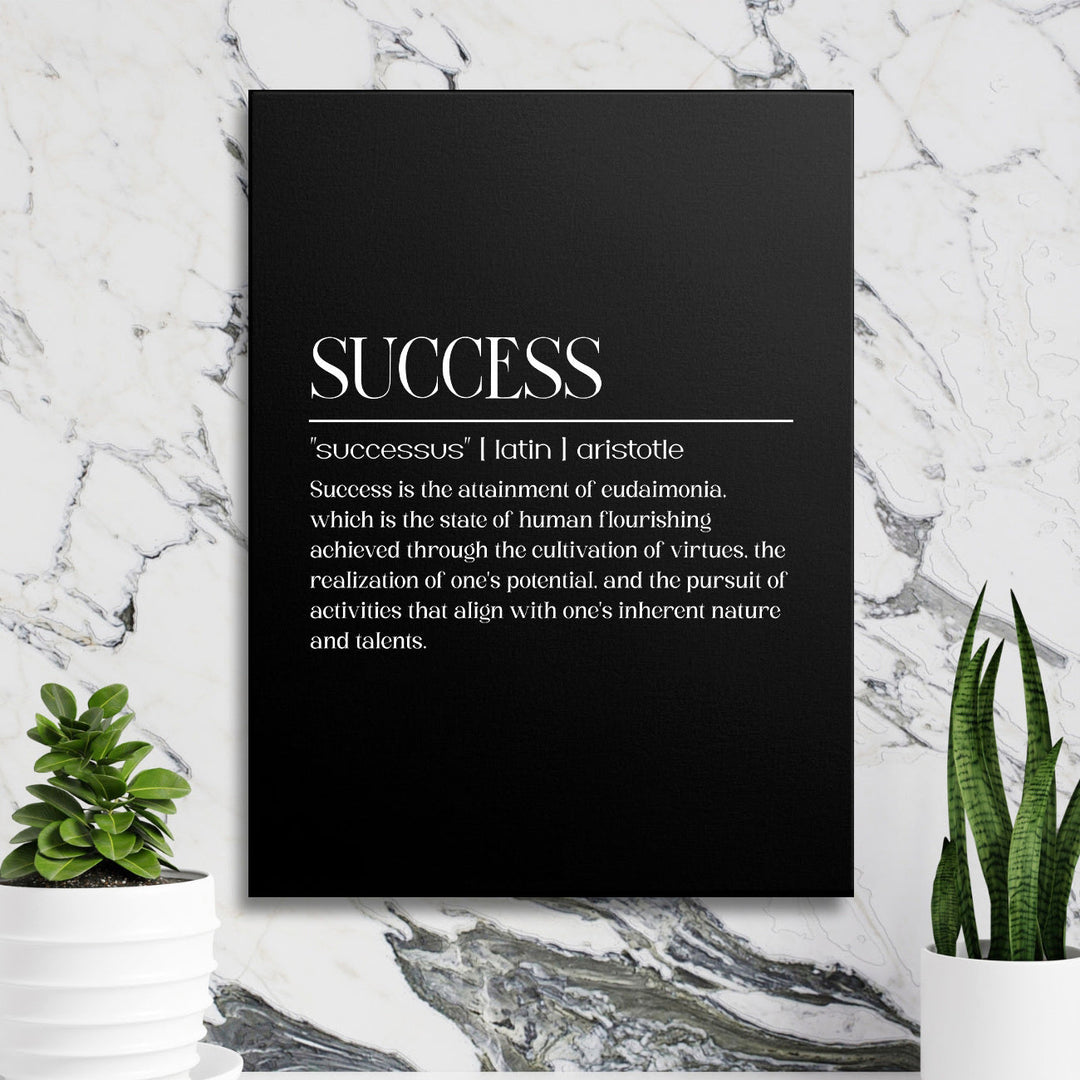 Motivational canvas print with a white Aristotle quote on a black background, marble wall and green plants