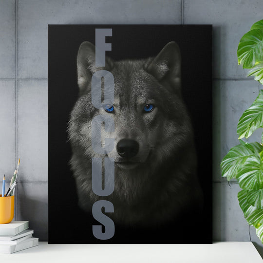 Motivational canvas wall art with a blue-eyed wolf portrait and FOCUS text in an office.